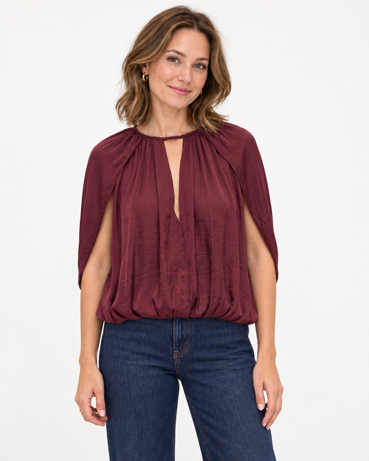 Silky Draped Cape Sleeve Blouse in burgundy, worn with dark jeans