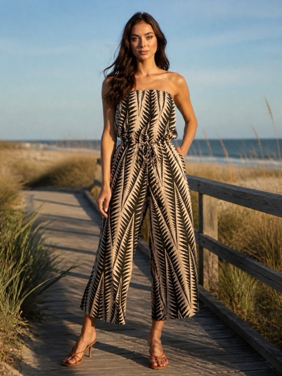 Shop Jumpsuits - woman in a White Lotus jumpsuit on a beach boardwalk